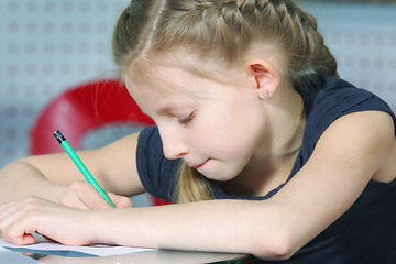 Image showing Little girl drawing with pencil