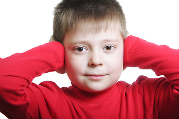 Image showing Boy in red shutting ears