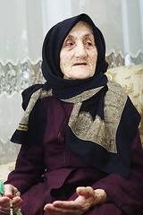 Image showing Elderly woman with beads