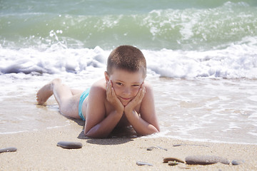 Image showing Kid laying on beach