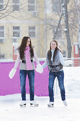 Image showing Women ice-skating holding hands