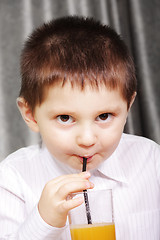 Image showing Kid drinking juice