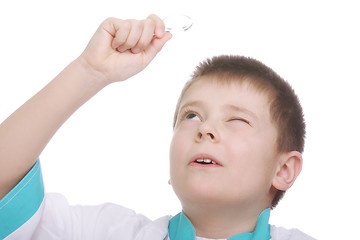 Image showing Kid looking up through magnifying glass