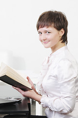 Image showing Businesswoman at desk with book