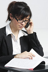 Image showing Brunette businesswoman reading magazine