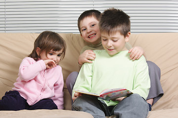 Image showing Three children reading book