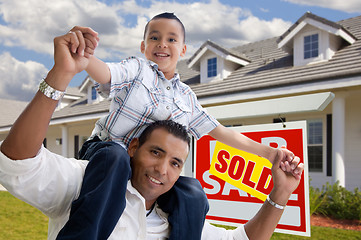 Image showing Hispanic Father and Son with Sold Real Estate Sign