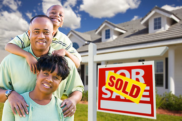 Image showing African American Family with Sold For Sale Sign and House