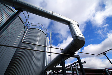 Image showing industrial piping and tanks against blue sky