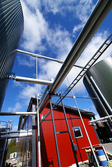 Image showing industrial piping and tanks against blue sky