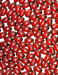 Image showing Red capsules is spilt