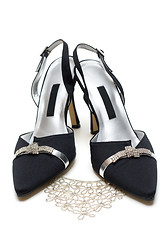 Image showing Feminine black loafers and necklace