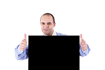 Image showing Young businessman holding a blackboard displaying the sign of success