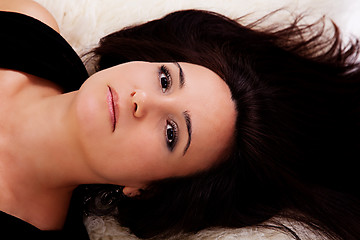 Image showing beautiful and sad woman lying