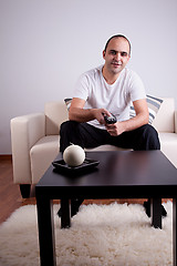 Image showing casual man watching tv on sofa