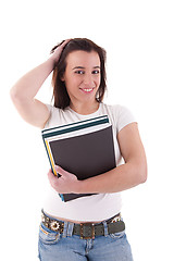 Image showing female student smiling and holding notebooks