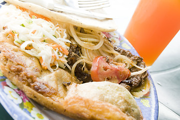 Image showing plate of street food with fresh mango juice leon nicaragua
