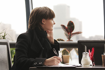 Image showing Pensive woman in black working in cafe