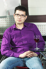 Image showing Serene guy in cafe with glass of wine