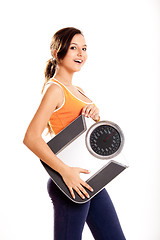 Image showing Athletic girl with a scale