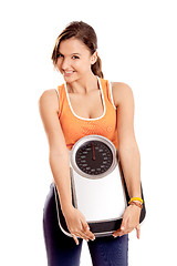 Image showing Athletic girl with a scale