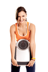 Image showing Athletic girl with a scale