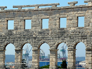 Image showing Croatia. Istria. Pula. Seaport cranes through windows of the Arena of Pula  