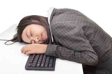 Image showing Office worker sleeping on desk