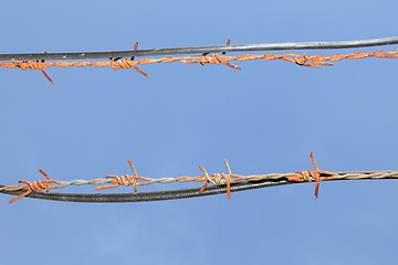 Image showing Barbed wires in sky