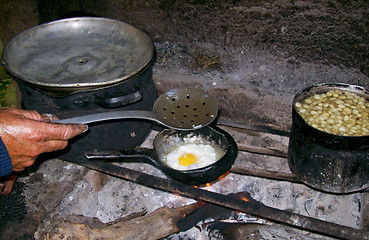 Image showing Cooking Woman in A Hut