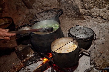 Image showing Cooking Woman in A Hut