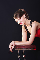 Image showing Young woman leaning on chair