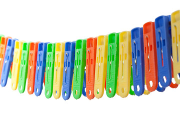 Image showing Colorful row of clothes pegs
