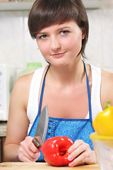 Image showing Woman with paprika and knife
