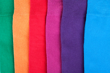 Image showing Different color clothes lay in row