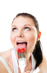 Image showing Woman lick paint brush for fun