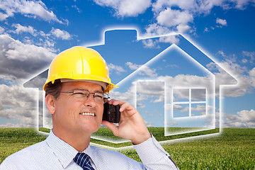 Image showing Contractor in Hardhat on Phone Over House, Grass and Clouds