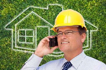 Image showing Contractor in Hardhat on Cell Phone Over House Icon and Grass