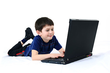 Image showing small boy with a laptop on a white background