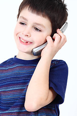 Image showing Smiling small boy calling from mobile phone