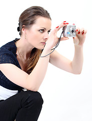 Image showing The attractive woman with digital camera on white background 