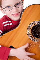 Image showing Cute boy with a guitar,