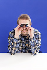 Image showing Man watches with binoculars