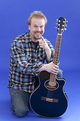 Image showing Portrait Of A Smiling Man With Guitar