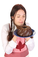 Image showing beautiful housewife smelling bundt cake