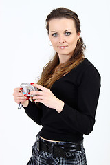 Image showing The attractive woman with digital camera  on white background 