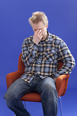 Image showing Tired Man Sitting On A Chair