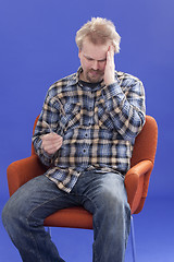 Image showing Tired Man Sitting On A Chair