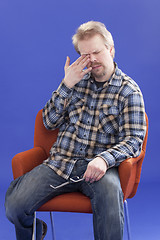 Image showing Tired Man Sitting On A Chair