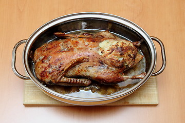Image showing Roasted duck in pan on the wooden desk